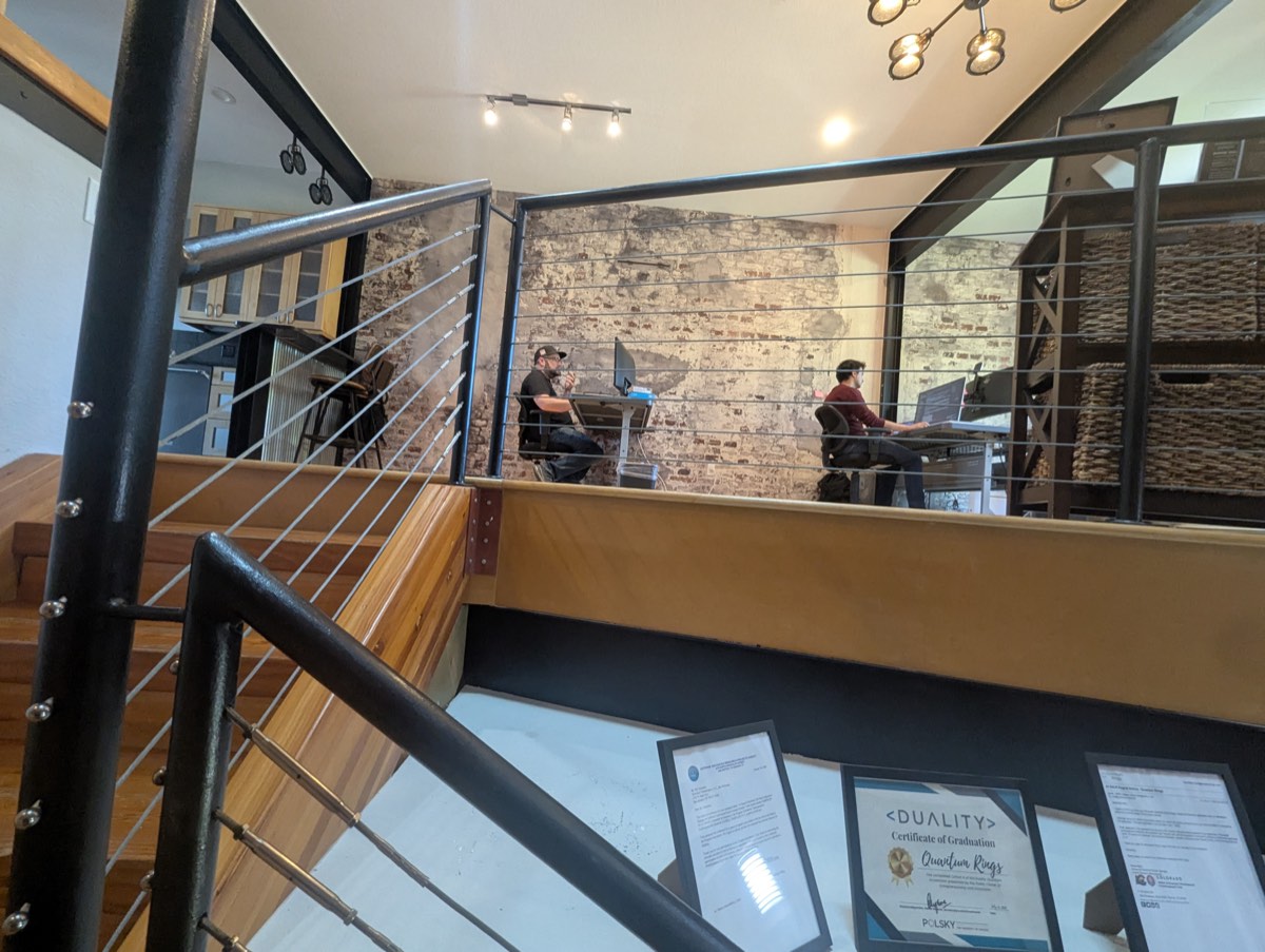 Desks on the upper level, with a few familiar certificates on display